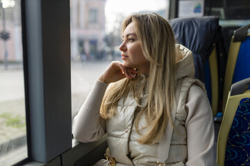 Fototapeta premium Pretty girl looking out the bus window 