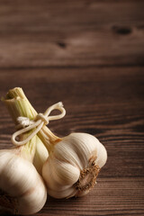 Heads of garlic on a wooden table. Close up. Copy space