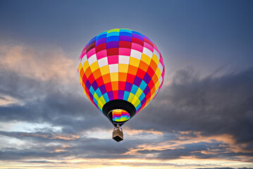 Fototapeta premium Colorful hot air balloon flying at sunset 