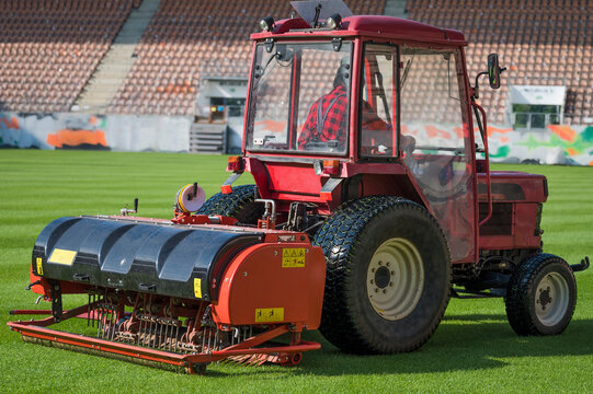 Man in tractor aerating a soccer field.