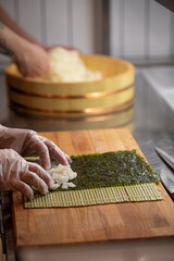Chef cooking maki sushi rolls with rice and nori © Hihitetlin