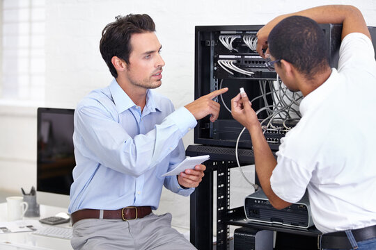 Hardware, information technology and engineering professional men repair motherboard in server room. Manufacturing or service, maintenance or technician and male coworkers support in office.