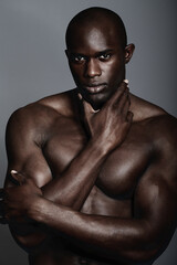 Muscle, body and skin, portrait of black man on dark background with and serious face for art...