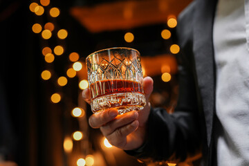Fototapeta na wymiar Closeup businessmen holding a glass of whiskey