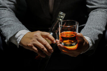 Closeup businessmen holding a glass of whiskey