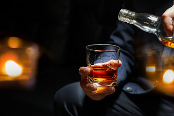 Closeup businessmen holding a glass of whiskey