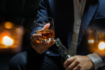 Closeup businessmen holding a glass of whiskey