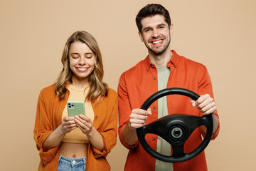 Young fearful couple two friend family man woman wear casual clothes looking camera hold head steering wheel driving car together isolated on pastel plain light beige color background studio portrait - Powered by Adobe