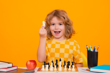 Child play chess on isolated background. Kid thinking about chess. The concept of learning and...