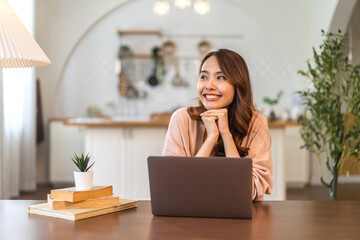 Young smiling asian woman happy relax use laptop conference work,learning education, shopping, study online, webinar, podcast,creative girl feel good, positive, success, excited, surprised at home