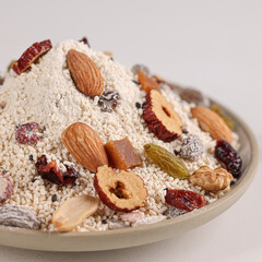 Nutritious breakfast made of dried lotus root powder and whole grains, indoor white background, nutritious porridge and healthy food