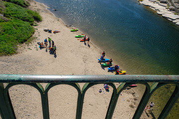 April 08, 2023. Balazuc, Ardèche department, France. Spring season kayaking tourism. View from the Ardèche River Bridge.