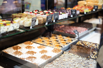 variety of sweet delicious cakes in the cafe window