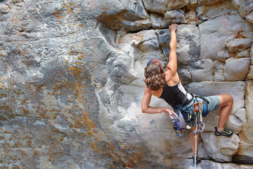 Rock climbing, fitness and challenge with woman on mountain for adventure and travel with space....
