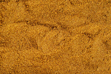 Pile of cumin powder as background, spice or seasoning as background. Ground or sifted garam...