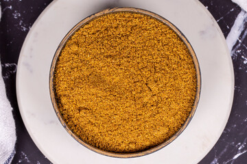 Cumin powder on dark background. spice or seasoning concept. Ground or sifted garam masala. indian spice. Top view