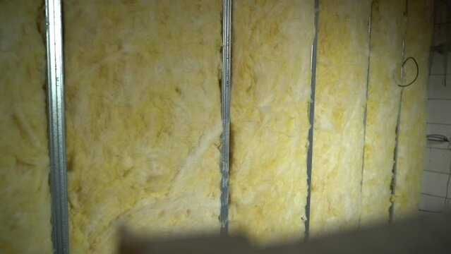 The partition between the rooms is filled with glass wool. Universal material for partition wall insulation