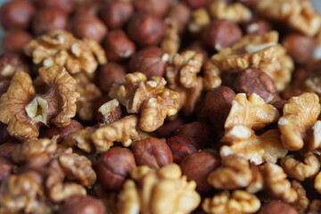 a mix of peeled walnuts and hazelnuts in close-up. The concept of healthy eating with natural products