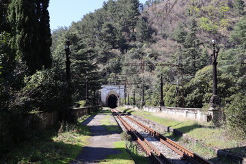 entrance arch in the old abandoned railway tunnel and passenger platform in Gagra, Abkhazia