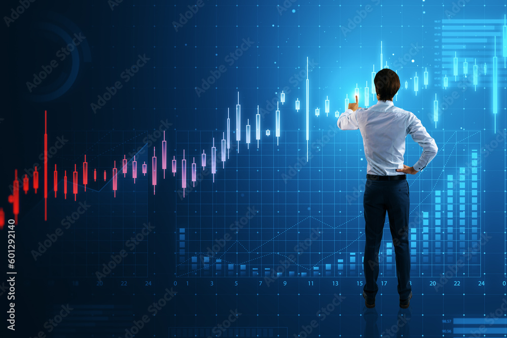Poster back view of young businessman using abstract glowing candlestick business chart on blue background.