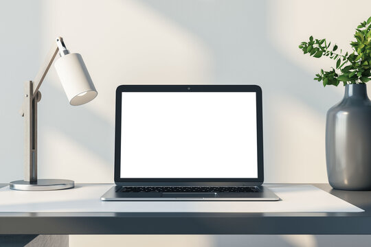 Closeup front view of a home white desk with blank screen modern laptop, lamp and homeplant on light wall background in sunny cozy interior, mockup. Home office and remote work concept. 3D Rendering