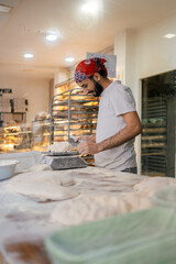 Arabic baker weighting dough with scale