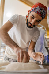 Arabic baker making shape on bread dough