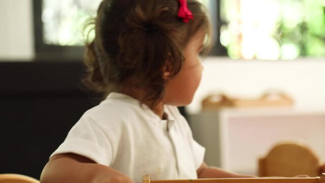 Child playing in a Montessori class with food themed objects and cards