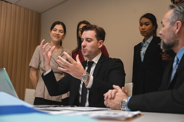 Business people, laptop and clapping hands in meeting for proposal, logo or reveal in office. Team, applause and corporate success by group celebrating achievement, project and job well done together