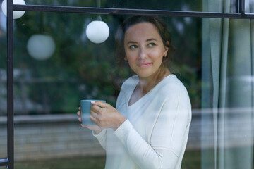 Young woman staring at the window