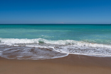 Fototapeta na wymiar Sea surf on the beach of Spain in spring. High quality photo