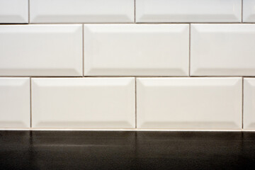 white ceramic textured rectangle glazy tile background with black floor  © jan_S