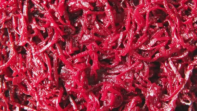 Beetroot salad with dressing and spices. Cooked chopped beet. Asian dish grated beets or beetroot and condiments, garlic, onion and pepper. Food background spinning. Copy space top view Full Frame