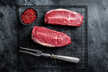 Raw top blade cut organic beef meat.  Black background. Top View