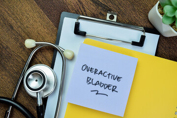 Concept of Overactive Bladder write on sticky notes with stethoscope isolated on Wooden Table.