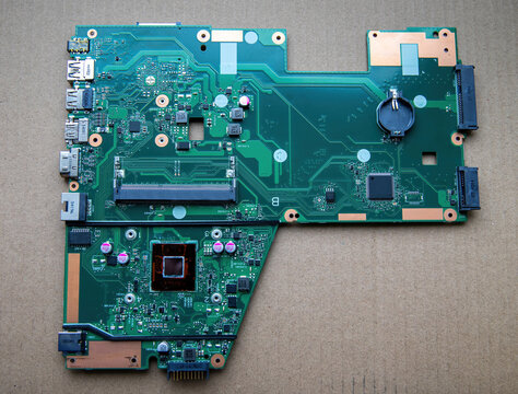 A computer motherboard for a laptop with a processor.