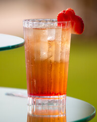 Cocktail with strawberries in nature.
