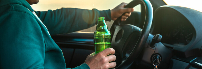 Man drinking beer while driving