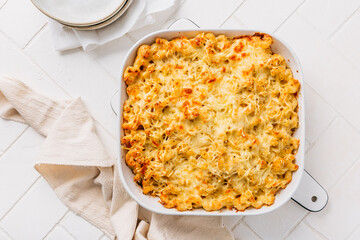Mac and cheese in casserole on white kitchen table