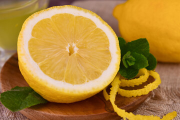 Half a fresh lemon and lemon zest. Close-up. 