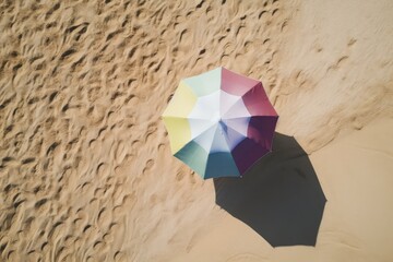 Aerial View of Pastel-colored Beach Umbrella and Towel on Sandy Beach - AI Generated