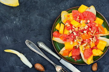 Fruit salad of citrus, chicory and nuts.