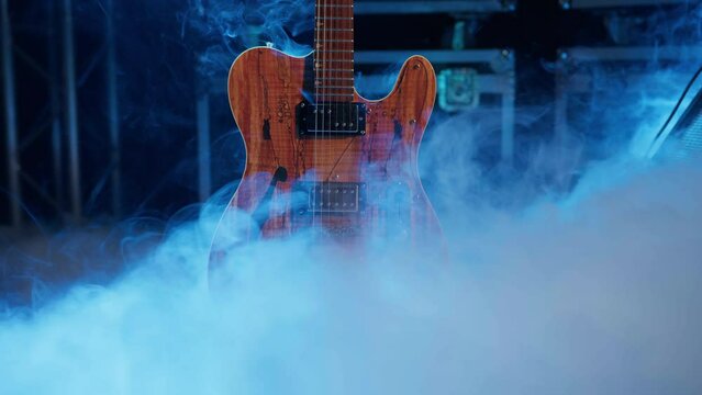 Concert stage in the fog before the concert. The guitar stands in the center of the stage