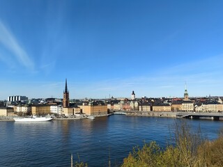 Fototapeta na wymiar Panoramic view of Gamla Stan - the old town of Stockholm against the backdrop of water and blue sky.