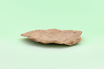 Stone podium for cosmetic product presentation. Abstract minimal backdrop. One rock form. Light...