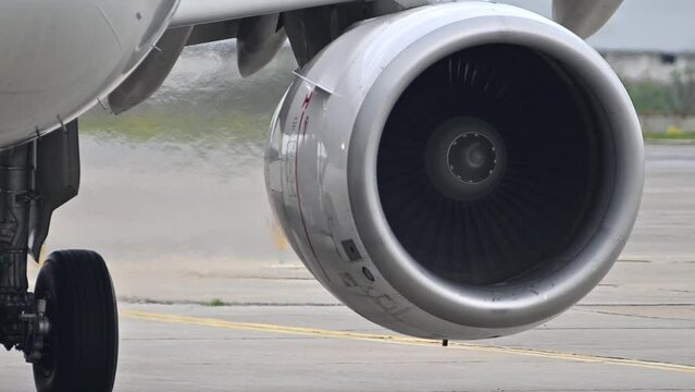 Huge airplane jet engine close up view moving forward heat haze distant airplane lining up behind. 4k super slow motion raw video 120 fps