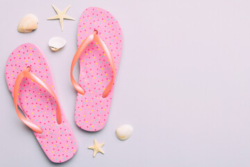 Flat lay composition with flip flops and seashell on colored background. Space for text top view