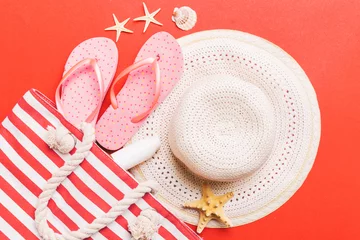 Zelfklevend Fotobehang beach accessories flat lay top view on colored background Summer travel concept. Bag with starfish and sea shell. Top view © sosiukin
