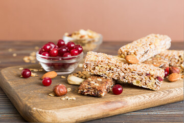 Various granola bars on table background. Cereal granola bars. Superfood breakfast bars with oats, nuts and berries, close up. Superfood concept