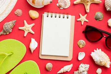 Blank writing book with summer beach accessories on background, copy space. Flat lay with copy space
